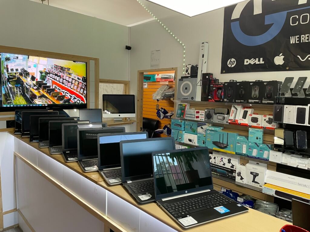 Laptops lined up on the service counter at the Tech Gate Computers repair shop in Windsor